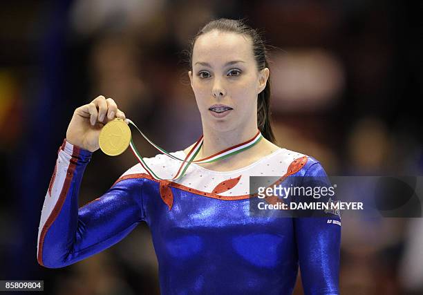 Gold medalist Britain's Elizabeth Tweddle poses on the podium of the uneven bars of the Third European Women's Artistic Championships on April 5,...
