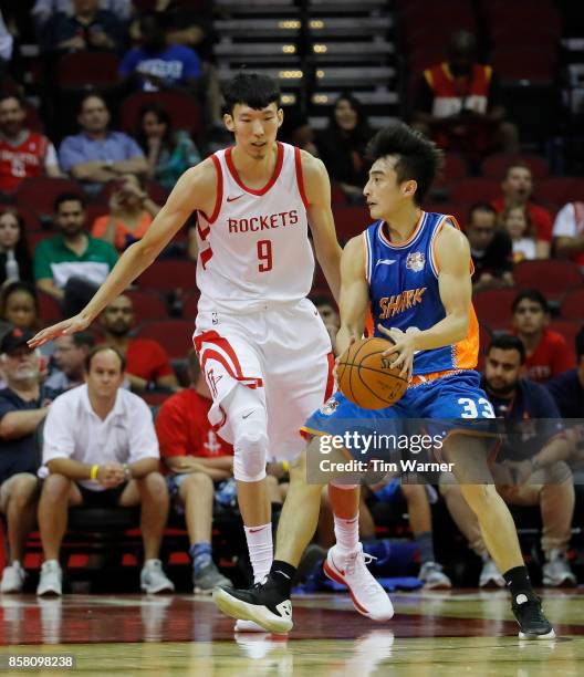 Zhou Qi of Houston Rockets defends Luo Hanchen of Shanghai Sharks in the first half at Toyota Center on October 5, 2017 in Houston, Texas. NOTE TO...