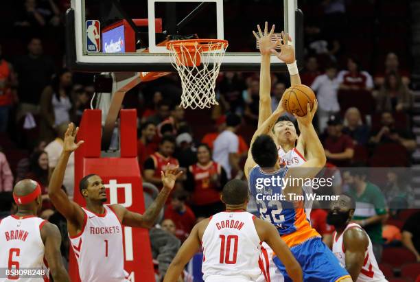 Zhou Qi of Houston Rockets blocks a shot by Zhai Yi of Shanghai Sharks in the second quarter at Toyota Center on October 5, 2017 in Houston, Texas....