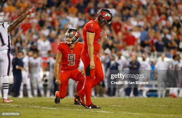 Kicker Nick Folk of the Tampa Bay Buccaneers reacts in front of punter Bryan Anger after missing a field goal during the fourth quarter of an NFL...