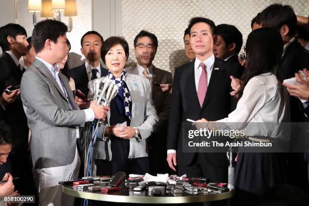 Tokyo Metropolitan Governor and Kibo no To head Yuriko Koike and the Democratic Party Preesident Seiji Maehara speak to media reporters after their...