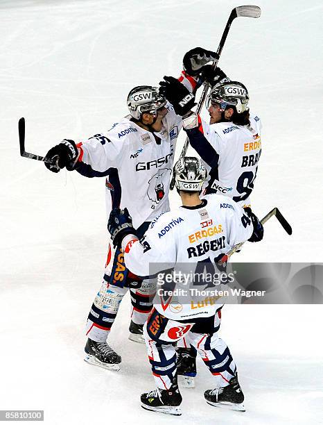 Brandon Smith celebrates the 3:4 with his team mates Richie Regehr and Constantin Braun during the DEL Play-Off semi final between Adler Mannheim and...