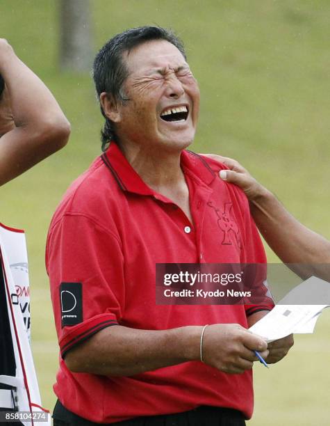 Masashi "Jumbo" Ozaki reacts after shooting his age in the second round of the Honma Tourworld Cup, a regular Japanese professional golf tour event,...