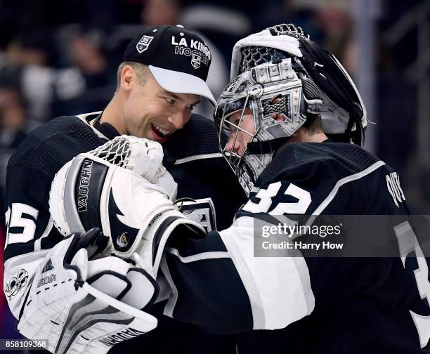 Jonathan Quick of the Los Angeles Kings celebrates a 2-0 win over the Philadelphia Flyers with Darcy Kuemper during opening night of the Los Angeles...