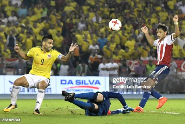 Radamel Falcao, of Colombia, vies for the ball with Anthony Silva and Angel Romero, of Paraguay, during a match between Colombia and Paraguay as part...