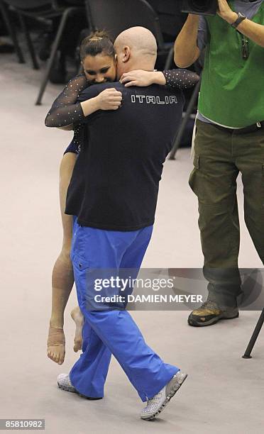 Italy's Vanessa Ferrari celebrates with a coach after her performance at the floor exercise during the Apparatus final of the Third European Women's...