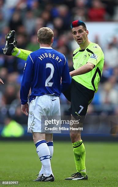 Paul Scharner of Wigan complains to Tony Hibbert of Everton about a high tackle during the Barclays Premier League match between Everton and Wigan...