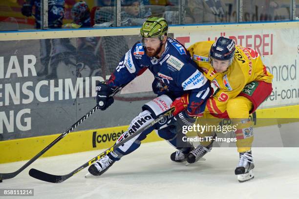 Christopher Brown of Iserlohn Roosters amd Maximilian Kammerer of Duesseldorfer EG battle for the ball during the DEL match between Iserlohn Roosters...