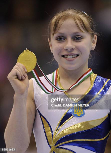 Ukraine's Anna Kalashnyk celebrates with her gold medal on the podium of the beam at the Third European Women's Artistic Championships on April 5,...