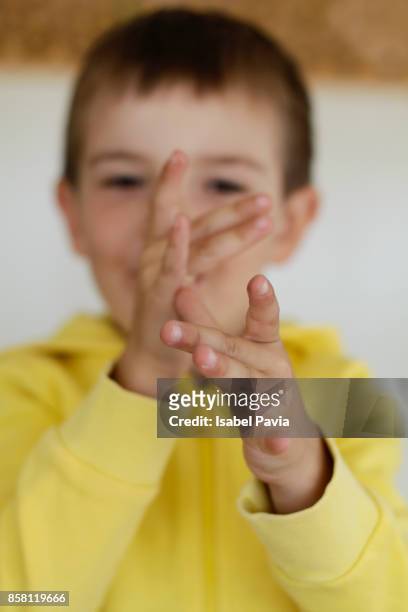 boy (5-) pulling face, holding hands to nose - kid middle finger imagens e fotografias de stock