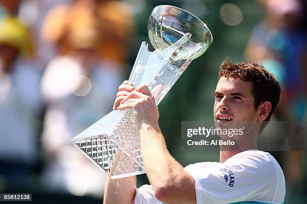 Andy Murray of Great Britain poses with the trophy after defeating Novak Djokovic of Serbia to win the men's final of the Sony Ericsson Open at the...