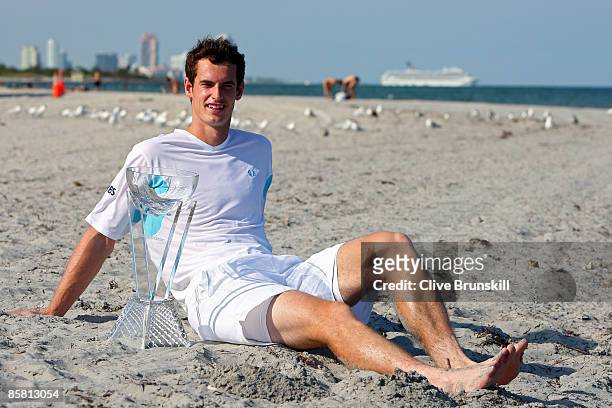Andy Murray of Great Britain poses on the beach with the trophy after defeating Novak Djokovic of Serbia to win the men's final of the Sony Ericsson...