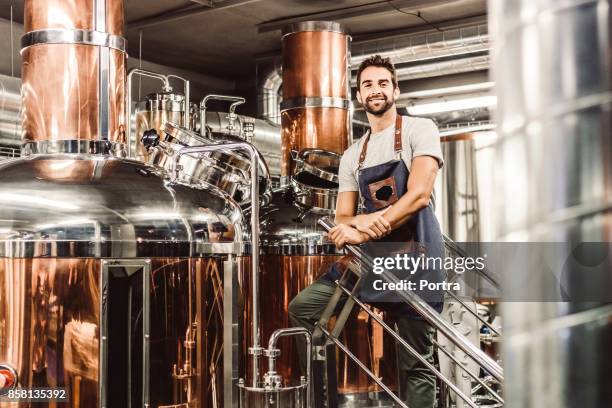 low angle portrait of male manager at brewery - microbrewery stock pictures, royalty-free photos & images