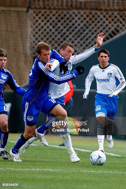 Cam Weaver of the San Jose Earthquakes tries to hold off Jimmy Conrad of the Kansas City Wizards at Community America Ballpark on April 5, 2009 in...