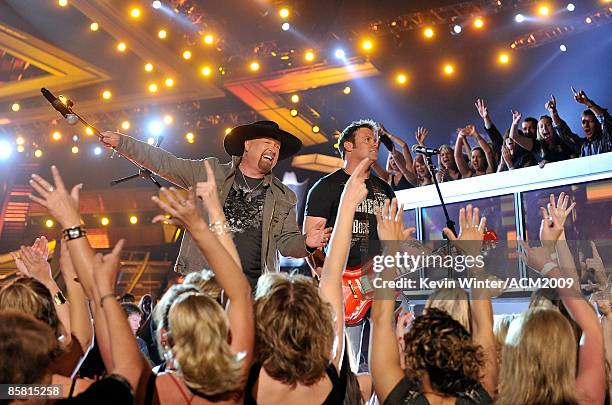 Musicians Eddie Montgomery and Troy Gentry of Montgomery Gentry perform onstage during the 44th annual Academy Of Country Music Awards held at the...