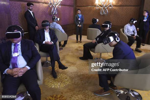 Participants and visitors test virtual reality headsets at the India Economic Summit, hosted by the World Economic Forum, in New Delhi on October 6,...