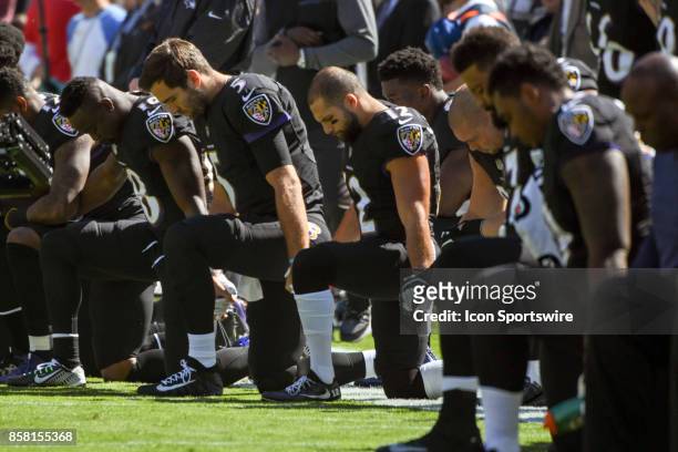 Kneeling are Baltimore Ravens wide receiver Chris Moore , quarterback Joe Flacco , and wide receiver Michael Campanaro prior to the National Anthem...