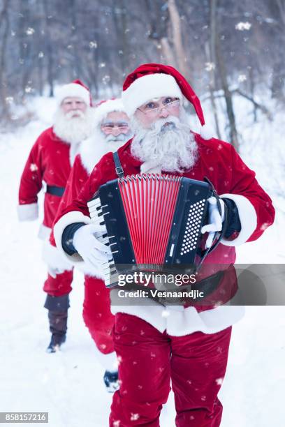 santa's at forest delivering presents - accordionist stock pictures, royalty-free photos & images