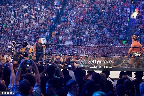 Actor Mickey Rourke steps into the ring while WWE Superstar Chris Jericho taunts him into a fight during WrestleMania 25 at Reliant Stadium on April...