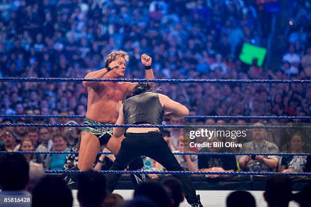 Superstar Chris Jericho gets a punch to the gut by actor Mickey Rourke as they duel during WrestleMania 25 at Reliant Stadium on April 5, 2009 in...