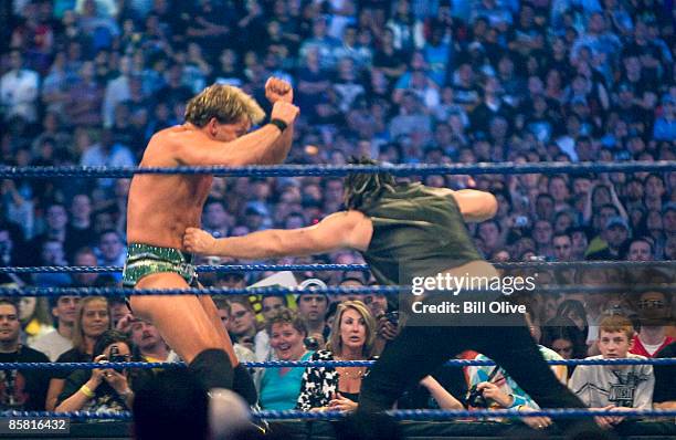 Superstar Chris Jericho gets a punch to the gut by actor Mickey Rourke as they duel during WrestleMania 25 at Reliant Stadium on April 5, 2009 in...