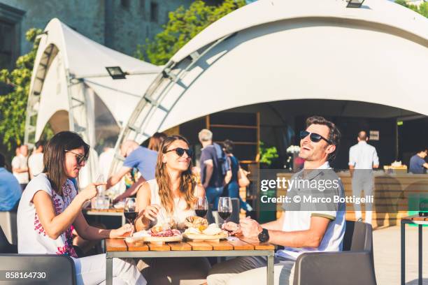 friends eating out in an outdoor restaurant, italy. - aperitif stock-fotos und bilder