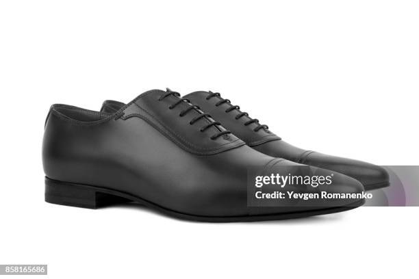 black leather male shoes, on white background - black male feet fotografías e imágenes de stock