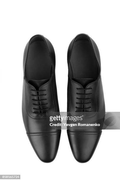 top view of classic black leather shoes on white - schuhe von oben stock-fotos und bilder