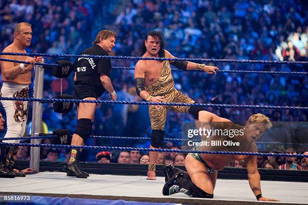 Former professional wrestlers Ricky "The Dragon" Steamboat and "Rowdy Roddy Piper look on as Jimmy "Superfly" Snuka steps into the ring to battle WWE...