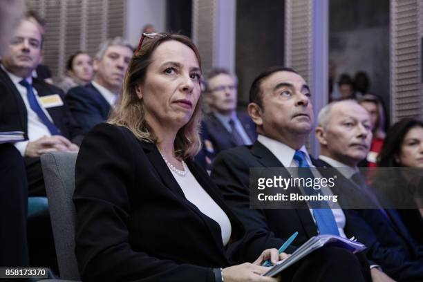 Clotilde Delbos, chief financial officer of Renault SA, left, and Carlos Ghosn, chairman of Renault SA, center, look on during a news conference to...