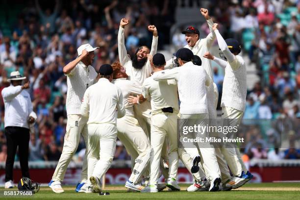 Moeen Ali of England celebrates with team mates after completing his hat trick to give England victory during the 3rd Investec Test between England...