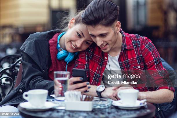 happy young couple browsing together on the phone - love 119 stock pictures, royalty-free photos & images