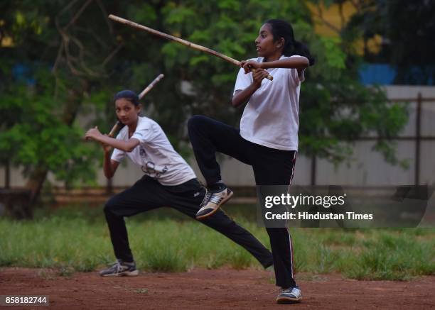 Anushka Mane and Sakshi Patil display Single Stick, a type of Silambam, a weapon based Indian Martial arts, on October 4, 2017 in Pune, India. The...