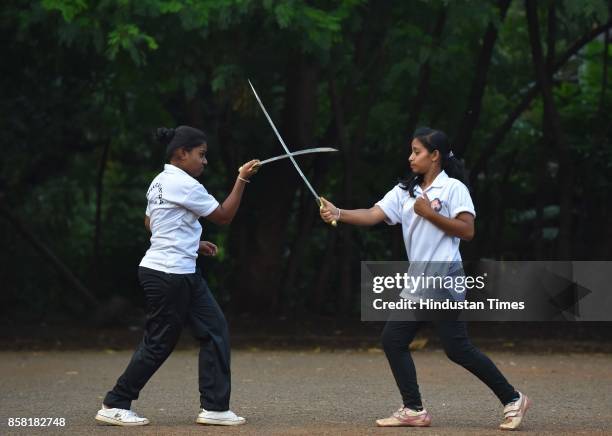 Purvi Ganve and Samruddhi Jadhav display Sword Fight, a type of Silambam, a weapon based Indian Martial arts, on October 4, 2017 in Pune, India. The...