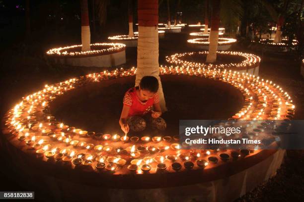 Thousands of Diyas lighten up by devotees during "Laksha Deepotsav" festival on the occasion of Sharad Purnima at Swami Gagangiri Maharaj Ashram,...