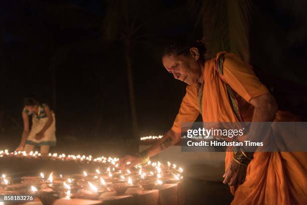 Thousands of Diyas lighten up by devotees during "Laksha Deepotsav" festival on the occasion of Sharad Purnima at Swami Gagangiri Maharaj Ashram,...