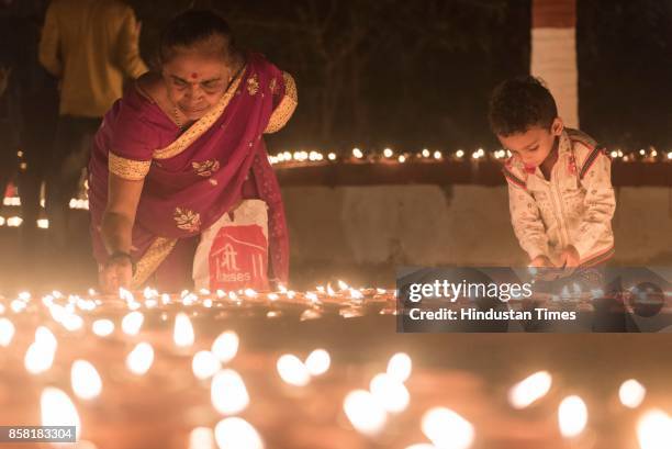 Thousands of Diyas lighten up by devotees during "Laksha Deepotsav" festival on the occasion of Sharad Purnima at Swami Gagangiri Maharaj Ashram,...