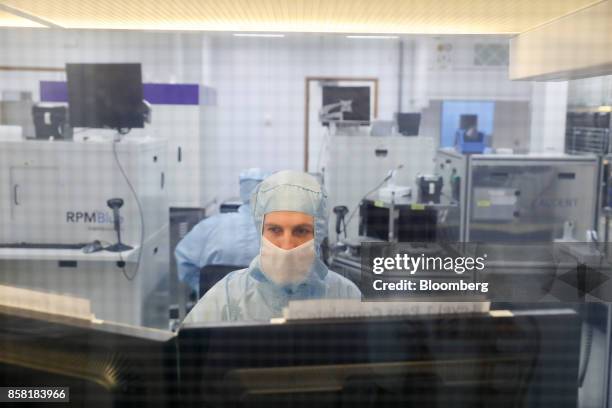 An employee tests a semiconductor wafer product in the 'clean room' laboratory at the IQE Plc headquarters in Cardiff, U.K., on Thursday, Sept. 28,...