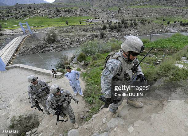 Soldiers from Charlie troop of 6-4 Cavalry patrol near a bridge in Nishagam, in Afghanistan's eastern Kunar province on April 5, 2009. About 17,000...