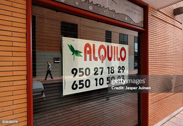 Man passes a closed down restaurant now for rent on April 4, 2009 in the coastal town of Almeria, southeast Spain. Before the real estate bubble...