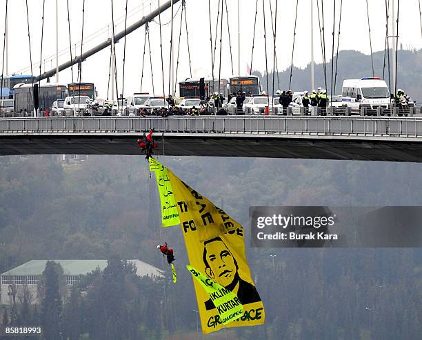 Greenpeace activists open a banner of US President Barack Obam on Bosphorus Bridge during a protest against Obama's visit on April 6, 2009 in...