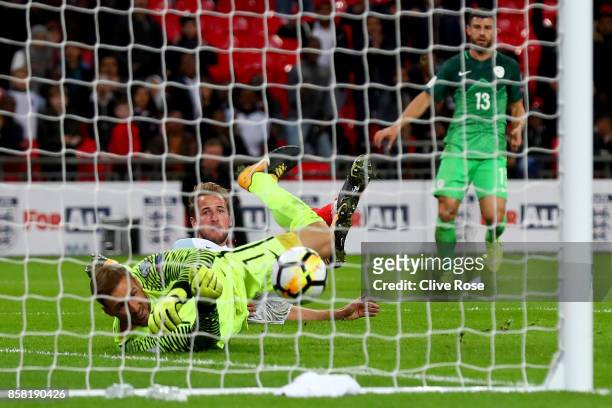 Harry Kane of England scores their first goal past Jan Oblak of Slovenia during the FIFA 2018 World Cup Group F Qualifier between England and...