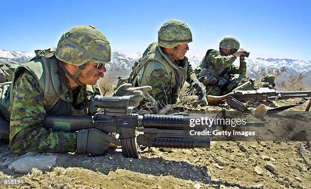 Soldiers from Princess Patricia's Canadian Light Infantry battalion hold their positions March 15, 2002 during a combat mission in the rugged...