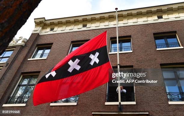 The flag of Amsterdam flies half mast in front of the office of late Amsterdam mayor Eberhard van der Laan in Amsterdam on October 6, 2017. Eberhard...