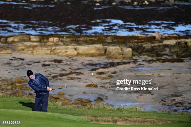 Musician, Mike Rutherford chips onto the 12th green during day two of the 2017 Alfred Dunhill Championship at Kingsbarns on October 6, 2017 in St...