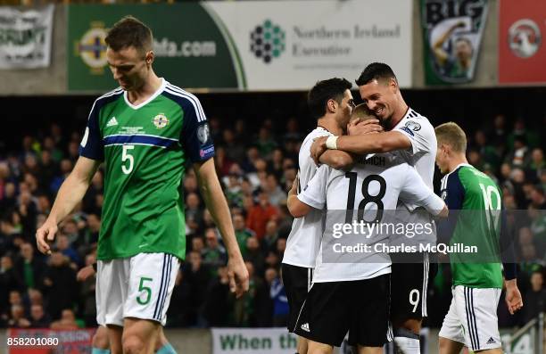 Joshua Kimmich of Germany is congratulated by team mates after scoring his side's third goal during the FIFA 2018 World Cup Qualifier between...