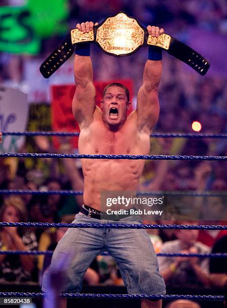 John Cena shows off his new World Heavyweight Championship belt after defeating The Big Show and Edge in triple threat match at "WrestleMania 25" at...