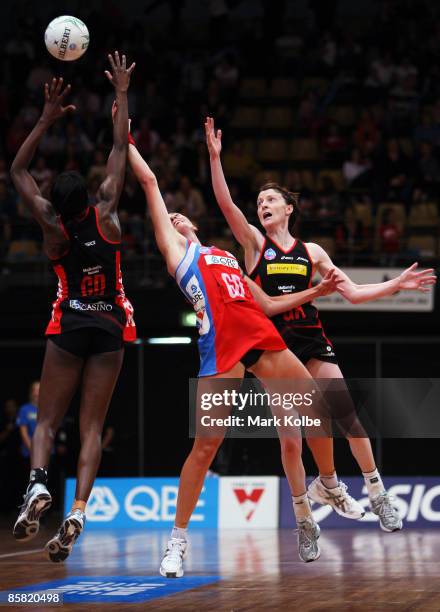 Rebecca Bulley of the Swifts competes for the ball against Sonia Mkoloma and Victoria Smith of the Taxtics during the round one ANZ Championship...