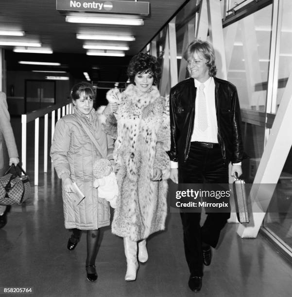 Joan Collins with daughter Katyana Kass and boyfriend Peter Holm at Heathrow after arriving from Los Angeles, 22nd December 1983.