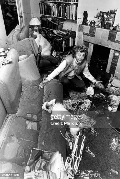 Mrs Irene Graham inspects damage to her home at Wulkes Head Square, Llandysul, following the floods, 20th October 1987.